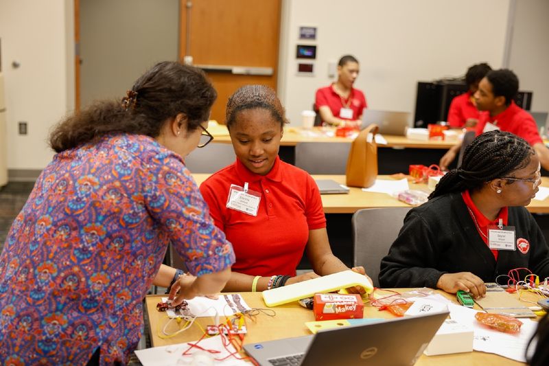 student with professor in a workshop