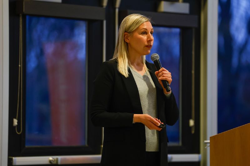 woman speaking into microphone