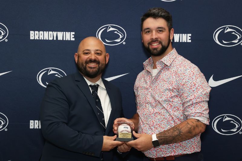 two men holding a baseball