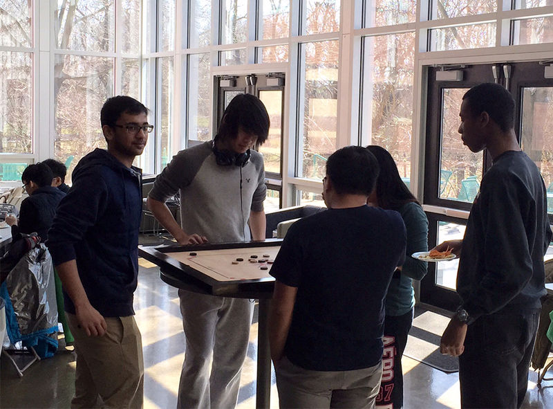 At the March Board Game Break, participants learned the Indian game of Carrom.