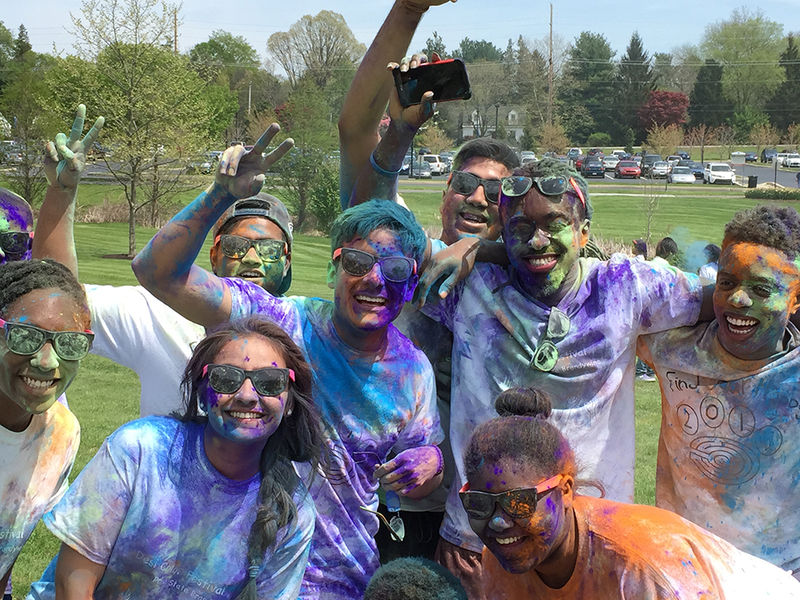 Students tossed colored powder on each other