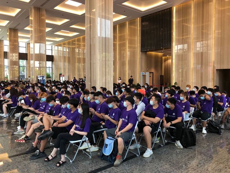 A group of students in a large hall for orientation