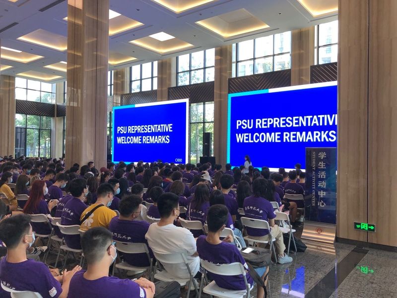 Students sitting in a large hall for orientation