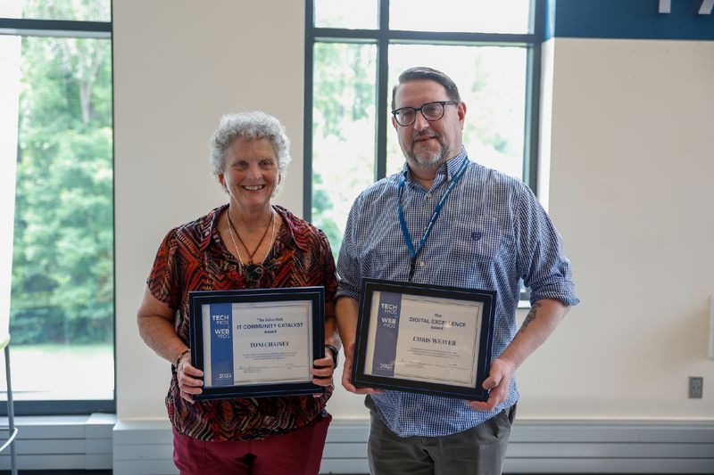 two people holding certificates