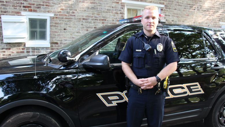 University Police Officer Luke Shivery next to patrol car