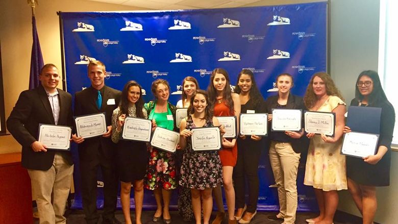 group of students pose with their awards