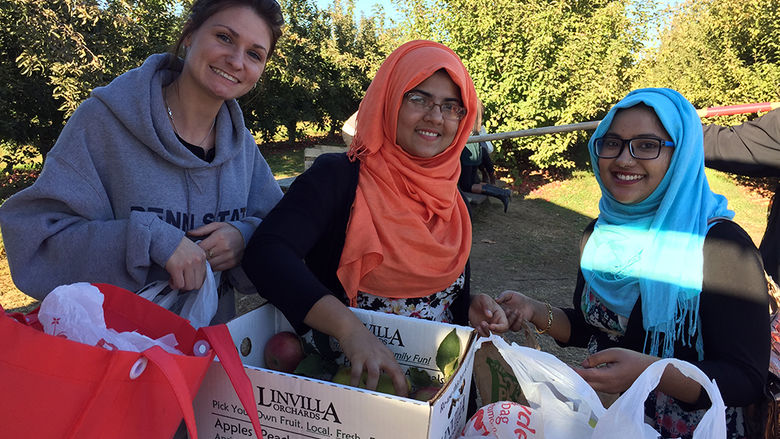 3 female students with apples