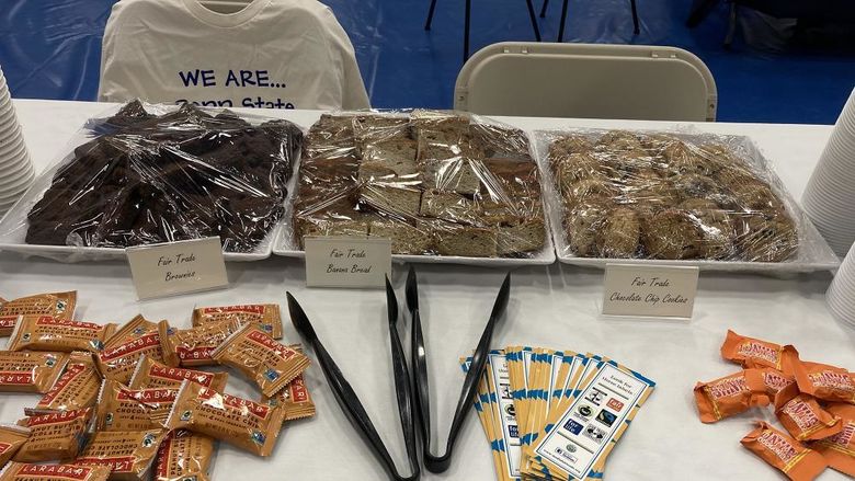 Brownies and cookies are in trays on top of a table.