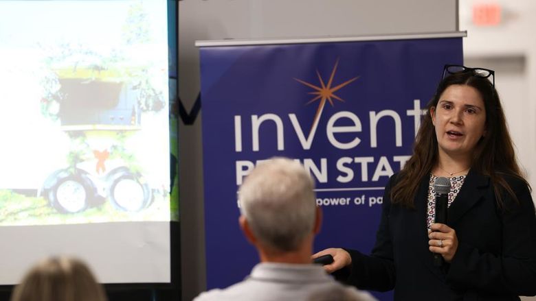 A woman with a microphone speaking to an audience