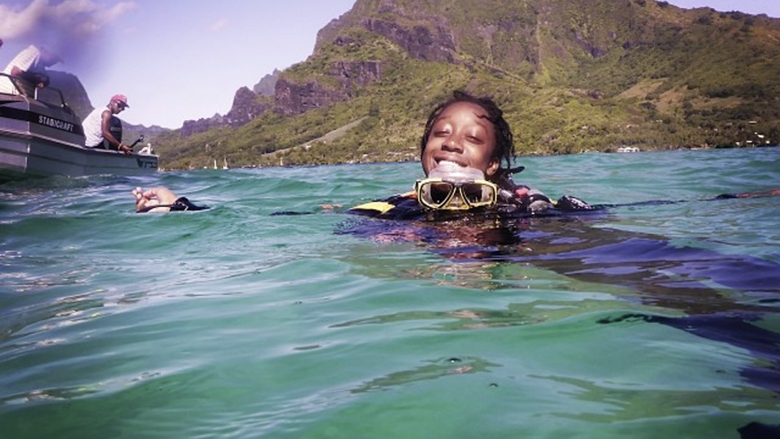 Camille smiling in the ocean wearing scuba gear