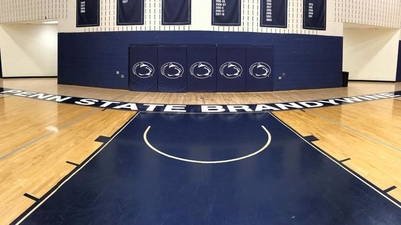 Penn State Brandywine gym floor showing Penn State athletics logos.