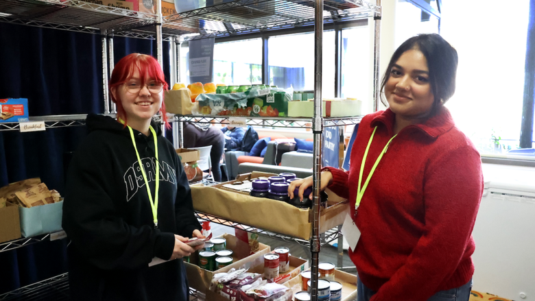 Students standing in front of the Center for Social Impact's food pantry