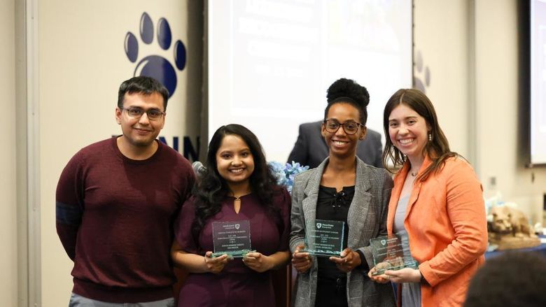 Three women accepting awards from a man