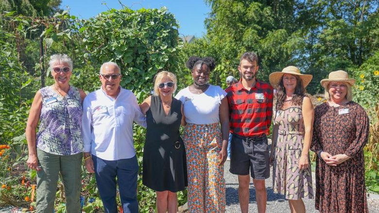 group of people smiling in garden