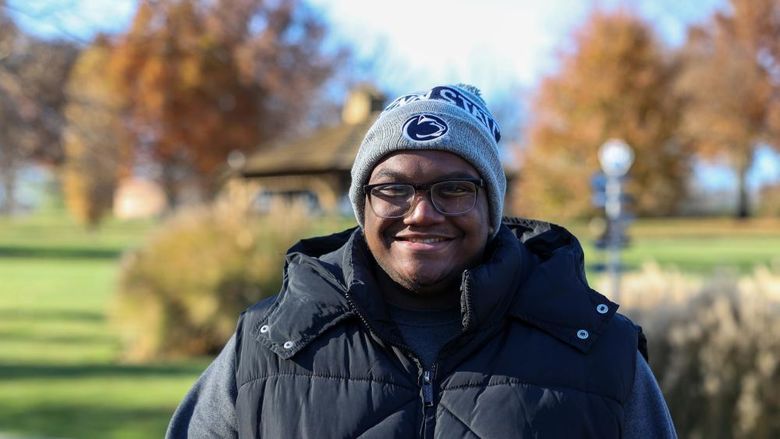 Jared McGill smiling wearing a Penn State winter hat