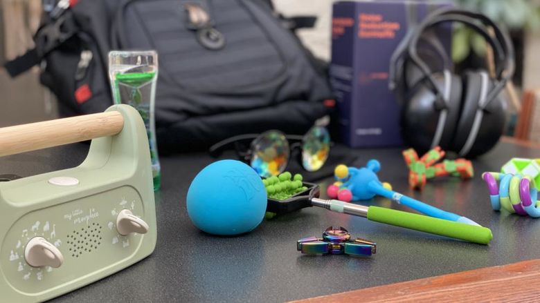 photo of black backpack with sensory tools surrounding it