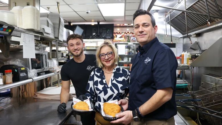 Marilyn and two epic double decker employees holding inside-outs, one of the restaurant's signature dishes