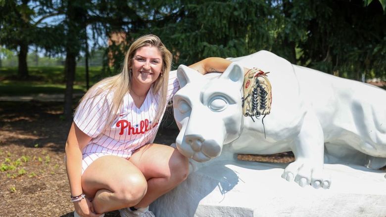 Farrell Everett in Phillies uniform with glove next to Nittany Lion
