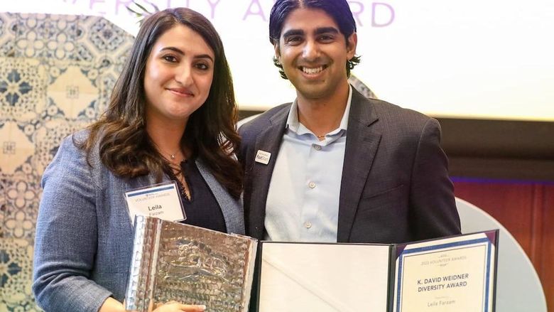 two people receiving and giving an award