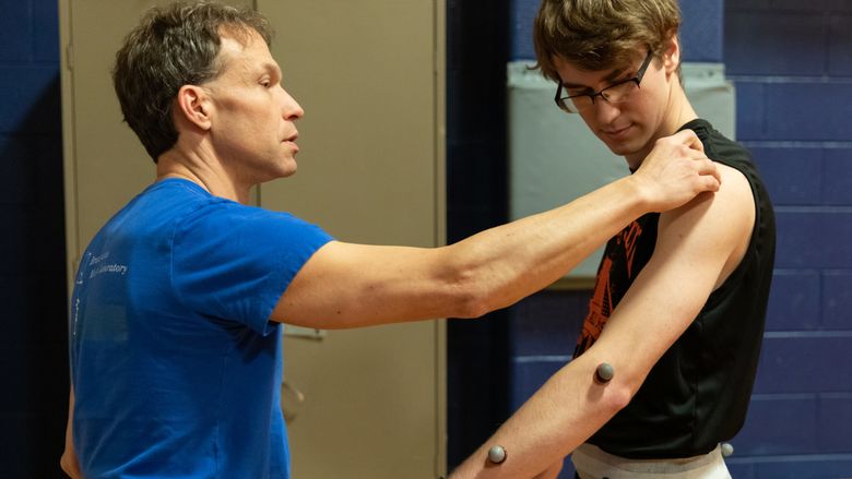 Penn State Brandywine's Tim Niiler attaching retroreflective markers  to a research participant.