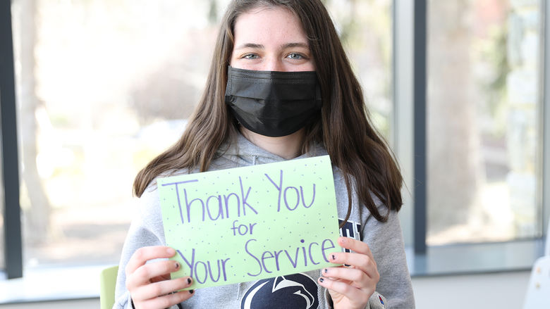A Brandywine student writing a letter thanking first responders. 