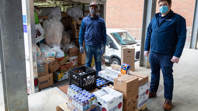 Neil LaGreca and James Parker with food to be donated.  