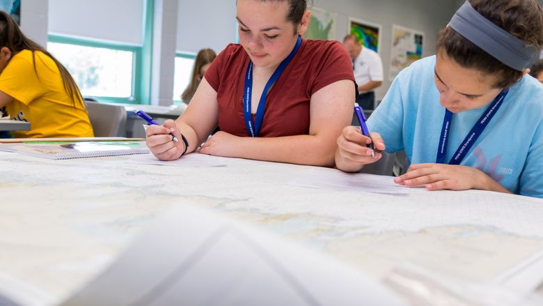 Girls working with nautical charts