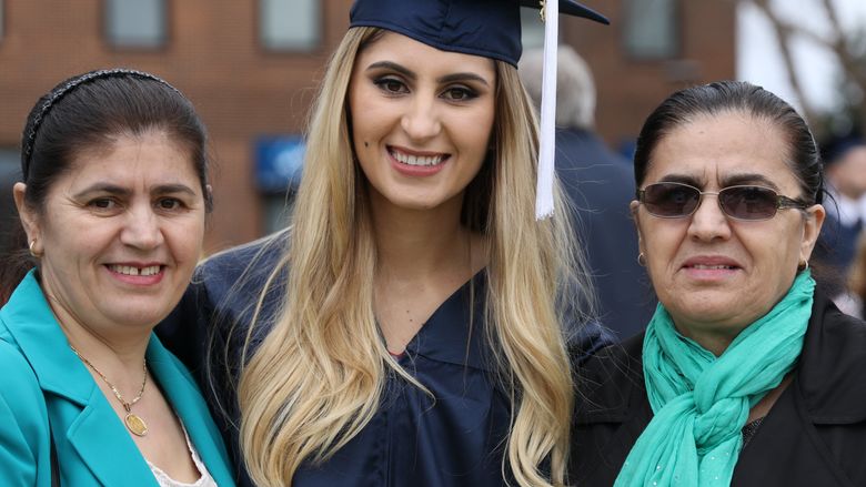 Student stands with family