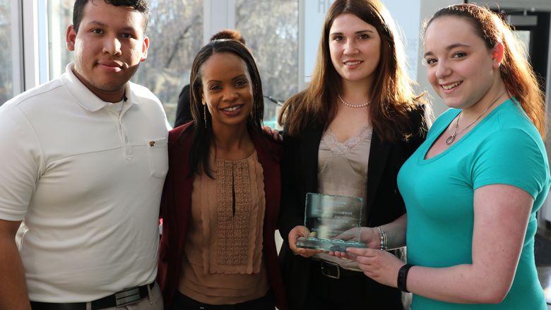 Students stand with Stephanie Jones witht their award.