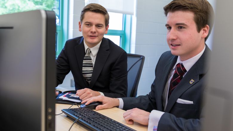 Coleman Hart and David Spencer working in a computer lab 