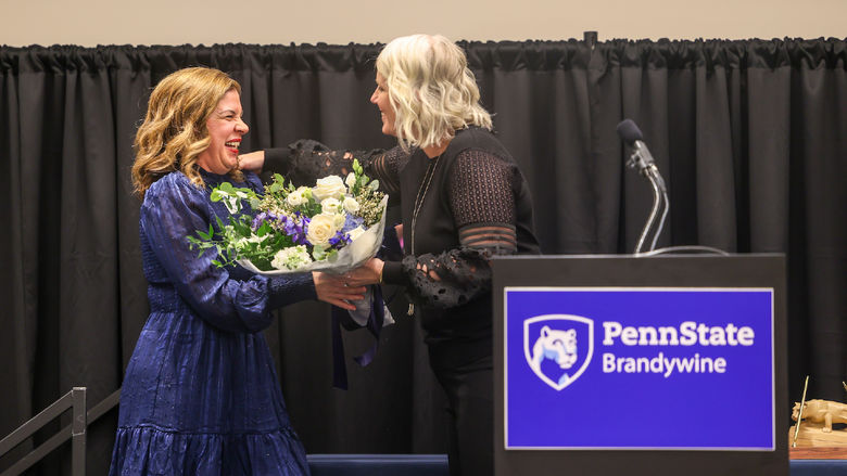 woman receiving flowers on a stage