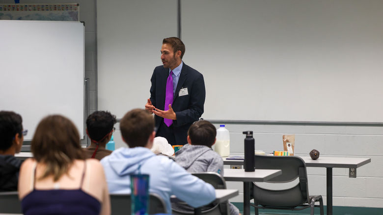 Drew Anderson speaking with students