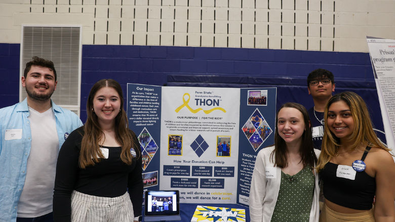 students standing in front of poster