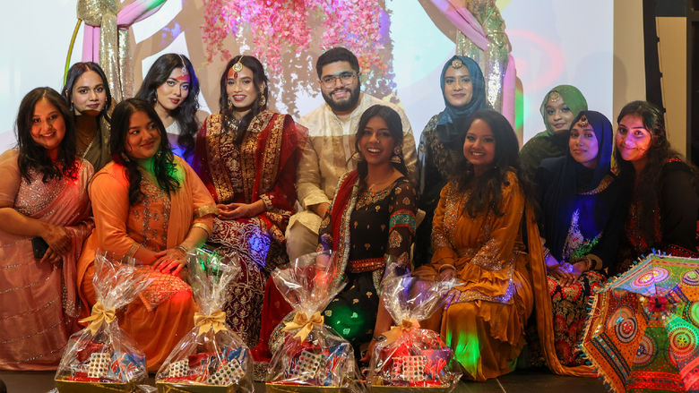 group of students at mock south asian wedding wearing traditional south asian attire
