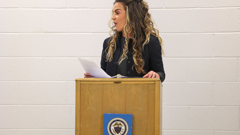 Kelly Shaw speaking at a podium