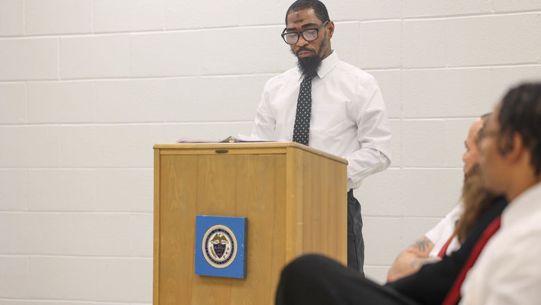 James speaking at a podium