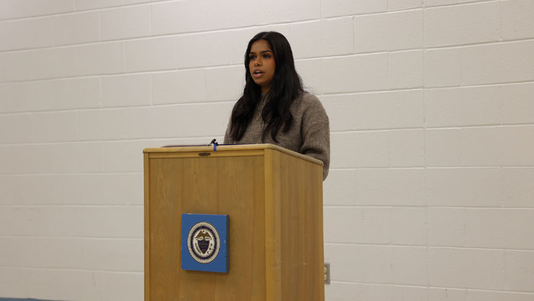 Ashni Voleti talking at podium