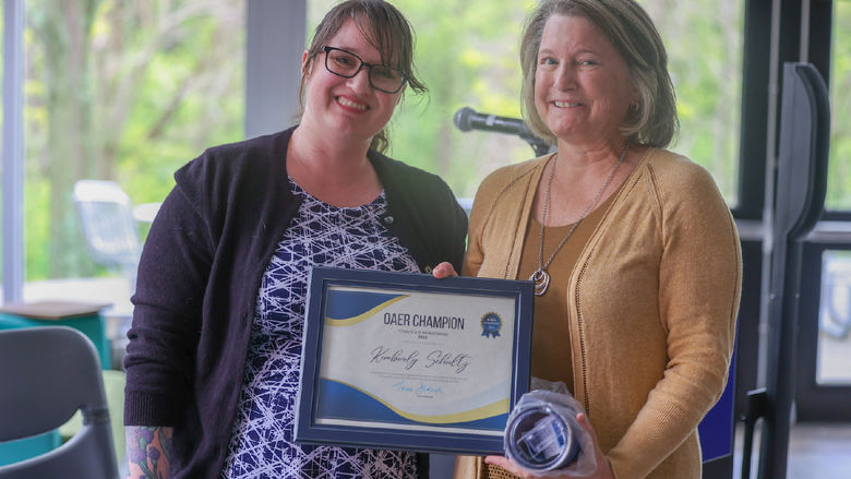 two women holding certificate