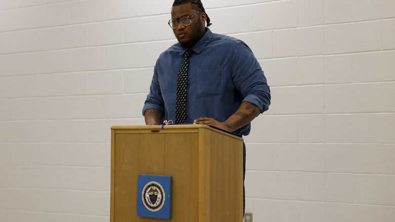 Kevin standing at a podium