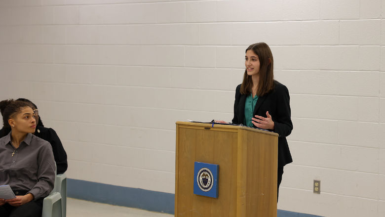 Aerin Yoder standing at a podium