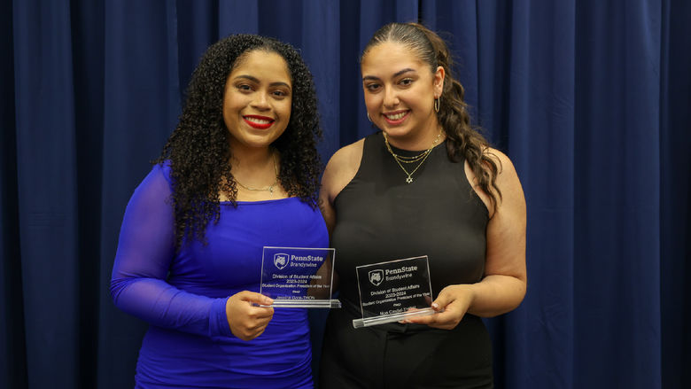 students holding awards