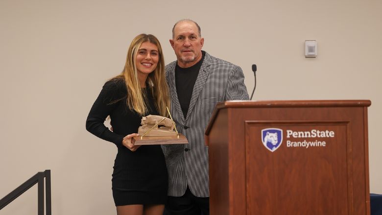 Arianna Segich and Mark Caserta posing with award