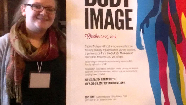 Megan Griffith standing next to her poster