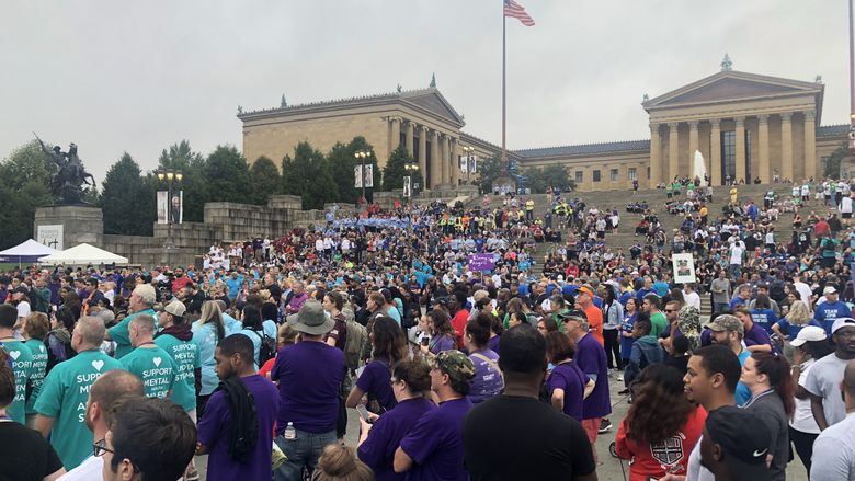 A large crowd of people at a walk that raises funds for the American Foundation for Suicide Prevention. 