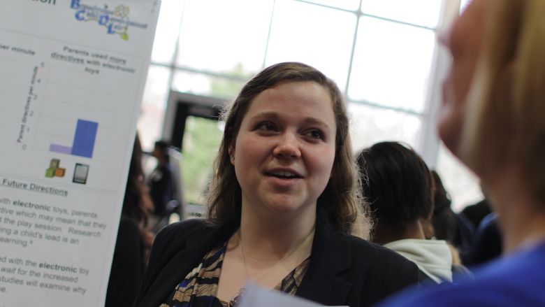 Lauren Lomas with her research poster