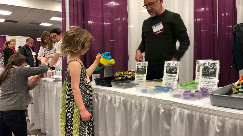 Mark Boudreau teaches a child about the environment. 