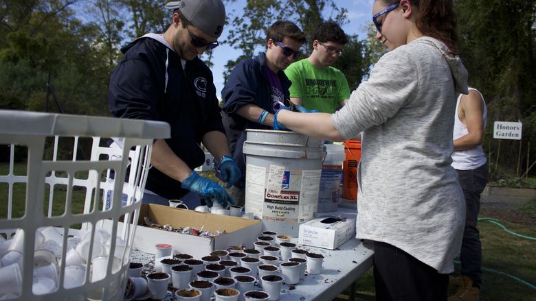 Students cleaning k-cups