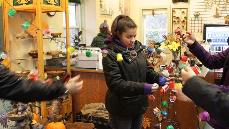 Student holding KCup String of Lights