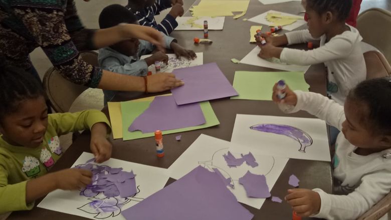 Penn State Brandywine international student Renu Bandaru works on an activity with preschool students at the T.M. Thomas Learning Center.