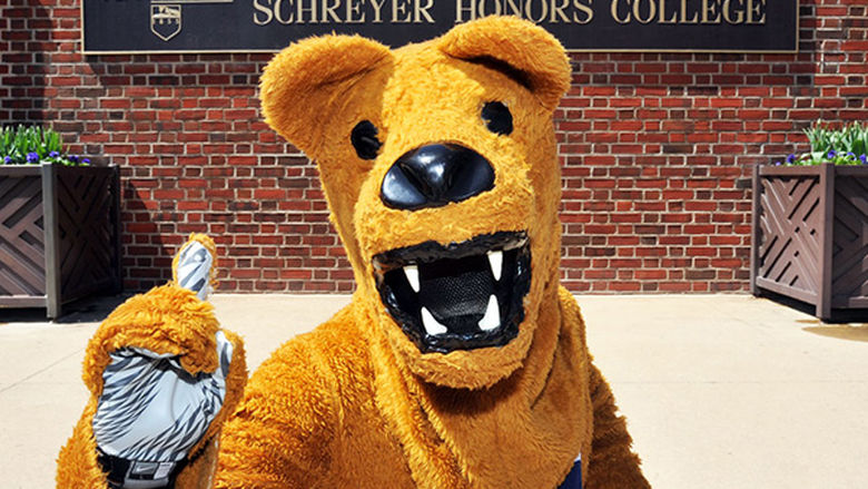 Nittany Lion mascot in front of Schreyer Honors College